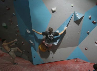 Males on bouldering wall