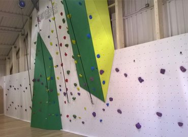 Indoor roped climbing wall and traverse walls