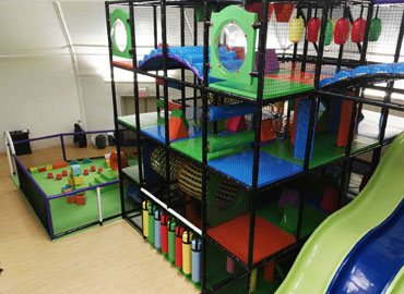 Indoor play structure with wave slides