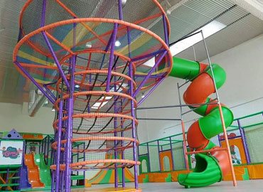 Commercial playground installation with tube slide