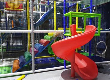 Commercial indoor play structure with spiral slide