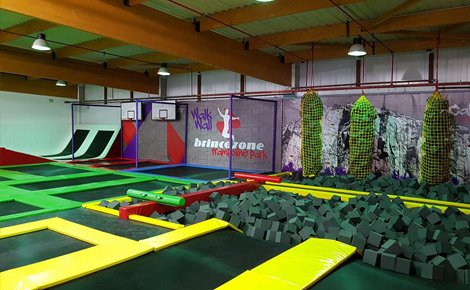 Trampoline park with battle beam and foam pit
